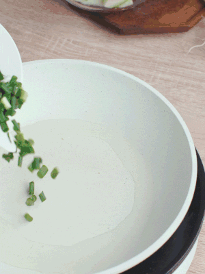 熱油下臘肉、蔥花煸炒，再下西葫蘆。